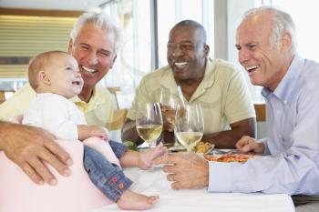 Royalty Free Photo of a Man With His Granddaughter and Friends at a Restaurant