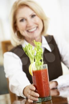 Royalty Free Photo of a Woman Drinking a Bloody Mary
