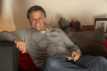 Royalty Free Photo of a Man Relaxing With a Remote Control