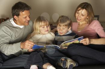 Royalty Free Photo of a Family Reading a Book