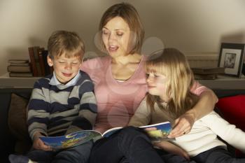 Royalty Free Photo of a Mother Reading to Her Children