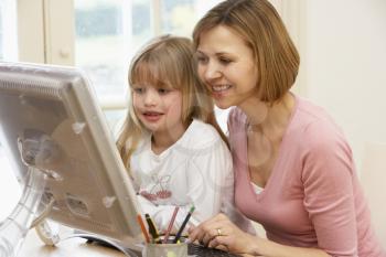 Royalty Free Photo of a Woman and Daughter Using a Computer