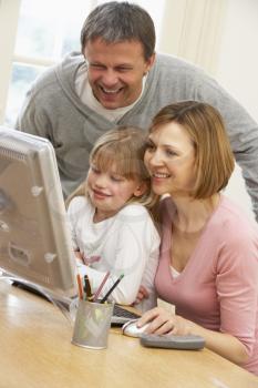 Royalty Free Photo of a Couple and Their Daughter at a Computer