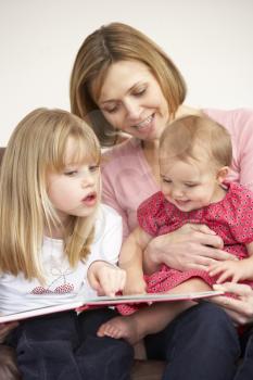 Royalty Free Photo of a Mother Reading to Her Daughters