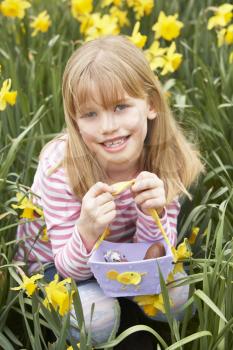 Royalty Free Photo of Young Girl With an Easter Basket in a Field of Daffodils