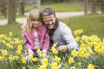 Royalty Free Photo of a Father and Daughter in Daffodils