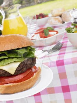 Royalty Free Photo of a Hamburger on a Table of Food