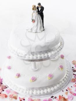 Royalty Free Photo of a Wedding Cake With a Bride and Groom on Top