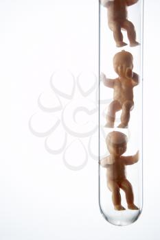 Royalty Free Photo of Baby Figurines in a Test Tube