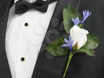 Royalty Free Photo of a Man Wearing a White Boutonniere