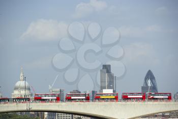 Royalty Free Photo of Double Decker Buses Lined Up On a Bridge With St Paul's Cathedral in the Background