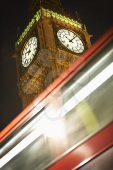 Royalty Free Photo of a Double Decker Bus Speeding By Big Ben