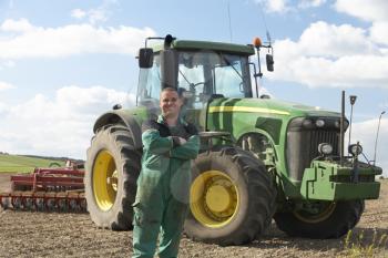 Royalty Free Photo of a Farmer With a Tractor