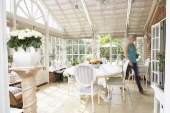 Royalty Free Photo of a Woman Walking Through a Conservatory