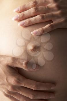 Royalty Free Photo of a Pregnant Woman Holding Her Belly