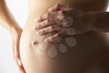 Royalty Free Photo of a Pregnant Woman Holding Her Belly
