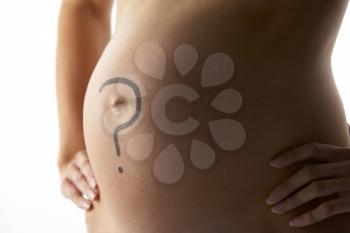 Royalty Free Photo of a Pregnant Woman With a Question Mark on Her Belly