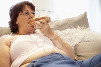 Royalty Free Photo of a Woman Eating Pastry