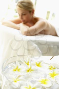 Royalty Free Photo of a Woman on a Massage Table With Flowers in the Foreground