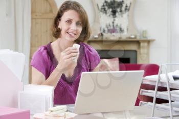 Royalty Free Photo of a Woman Eating Lunch at Her Desk
