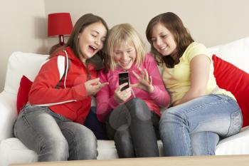 Royalty Free Photo of Girls Sending a Text Message