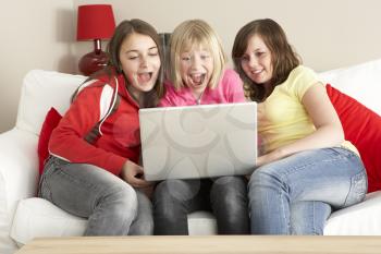 Royalty Free Photo of a Group of Girls With a Laptop