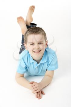 Royalty Free Photo of a Little Boy Lying on the Floor