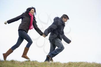 Royalty Free Photo of a Couple Running in a Park