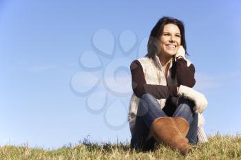 Royalty Free Photo of a Woman Sitting Outside