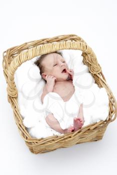 Royalty Free Photo of a Baby in a Wicker Basket