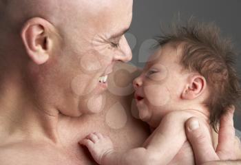 Royalty Free Photo of a Father Holding a Baby