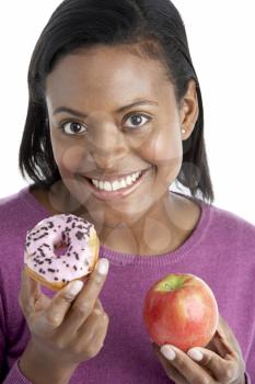 Royalty Free Photo of a Woman With a Doughnut and an Apple