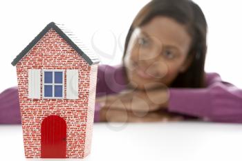 Royalty Free Photo of a Woman Looking at a Small House