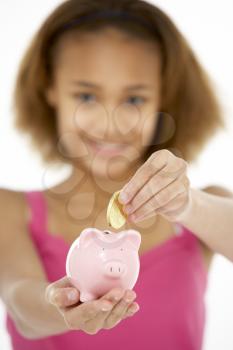 Royalty Free Photo of a Girl With a Piggybank
