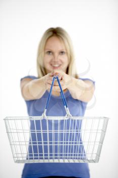 Royalty Free Photo of a Woman Holding a Shopping Basket