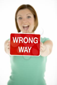 Royalty Free Photo of a Woman With a Wrong Way Sign
