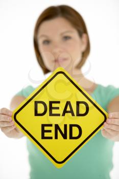 Royalty Free Photo of a Woman With a Dead End Sign