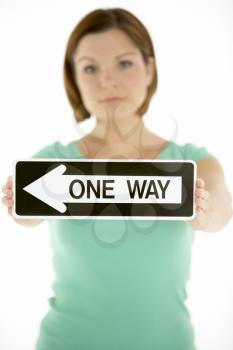 Royalty Free Photo of a Woman With a One-Way Sign