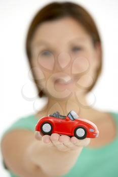 Royalty Free Photo of a Woman Holding a Red Convertible