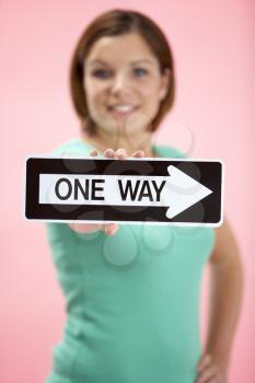 Royalty Free Photo of a Woman Holding a One-Way Sign