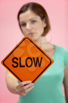 Royalty Free Photo of a Woman Holding a Slow Sign