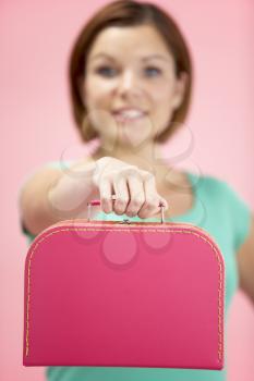 Royalty Free Photo of a Woman Holding a Small Suitcase