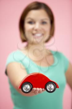 Royalty Free Photo of a Woman Holding a Small Car