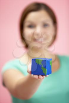 Royalty Free Photo of a Woman Holding a Cube Shaped Globe