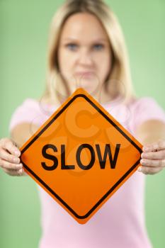 Royalty Free Photo of a Woman Holding a Traffic Sign