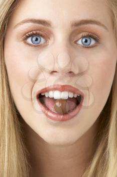 Royalty Free Photo of a Girl Eating a Chocolate