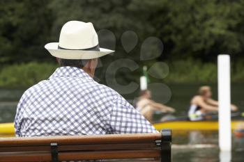 Royalty Free Photo of a Spectator Watching People Row