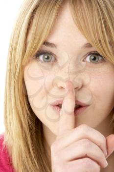 Royalty Free Photo of a Girl With Her Finger to Her Lips
