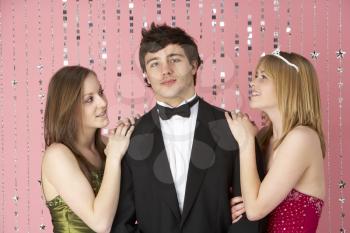 Royalty Free Photo of Two Girls With a Boy at a Party