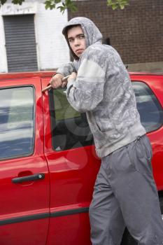 Royalty Free Photo of a Kid Breaking In to a Car